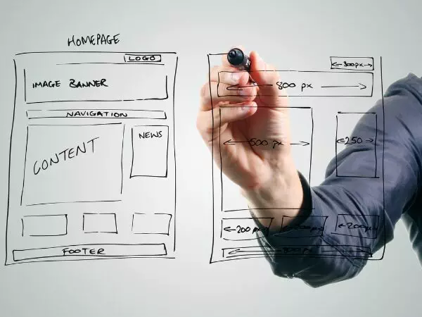 For the Website Design Setup and Hosting section. The image shows a person drawing a website wireframe on a transparent surface with a black marker. The wireframe outlines the layout of a homepage, including sections labeled